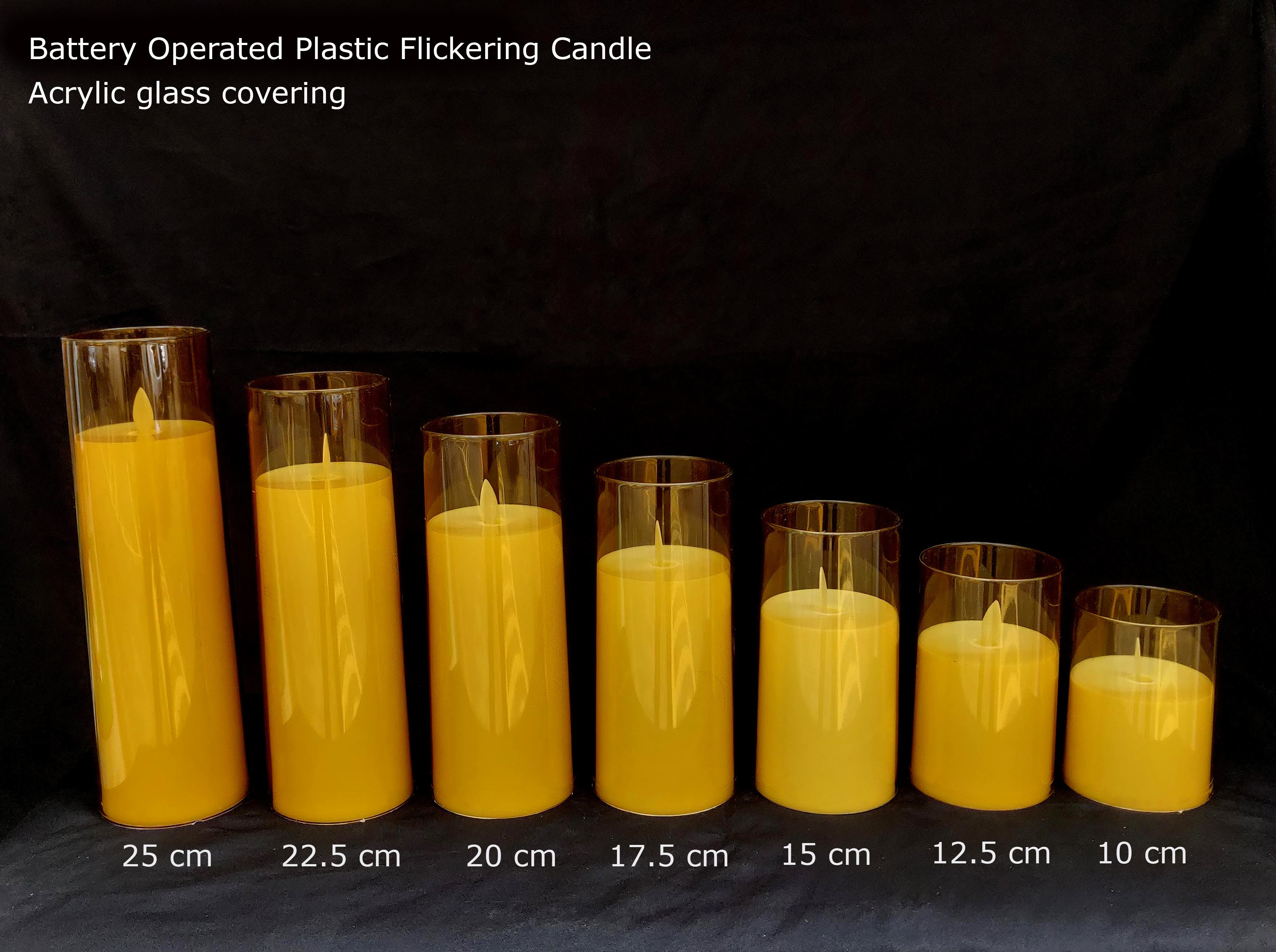Seven battery-operated plastic flickering LED candles in varying acrylic glass cylinder sizes Ginni Bloom Mumbai India