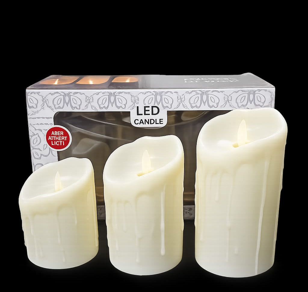 Three cream-colored LED pillar candles of varying heights Ginni Bloom Mumbai India